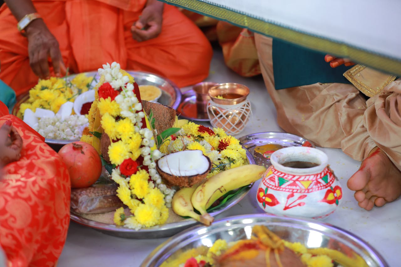 Vibrant arrangement of fruits and flowers in a traditional Indian ritual setting.
